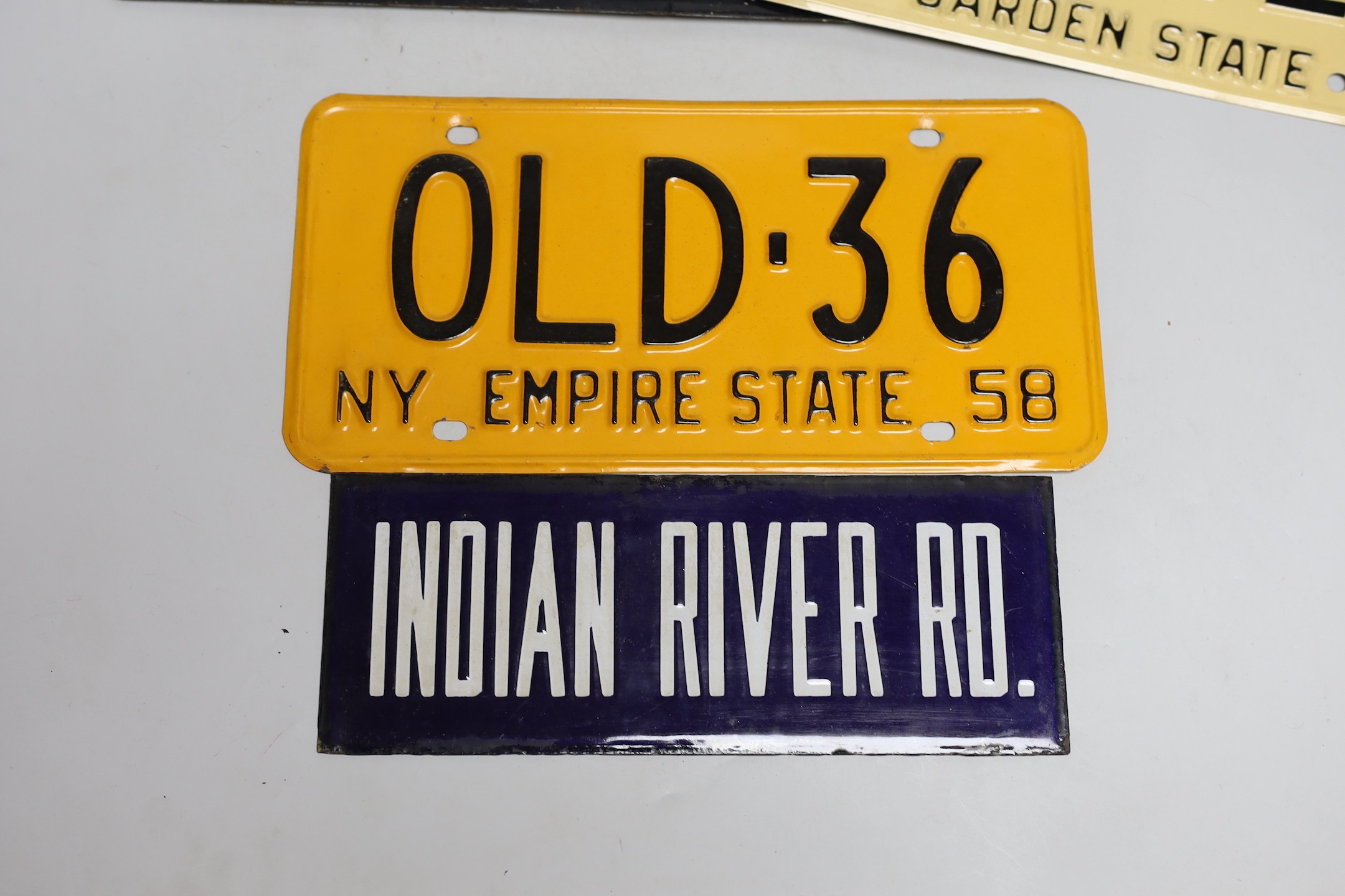 A mixed group of nine USA enamel car registration number plates